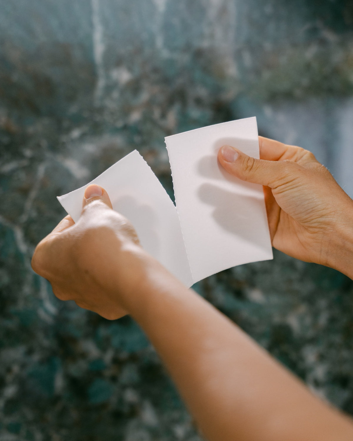 Tearing a The Good Stuff laundry sheet in half for a standard wash
